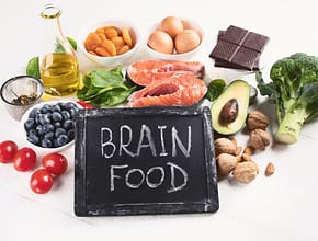 Brain Food chalk board sign with food in background