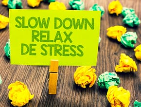 Sign on clothes clip saying to Slow Down Relax and De Stress