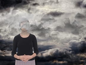 Woman with gray clouds over her