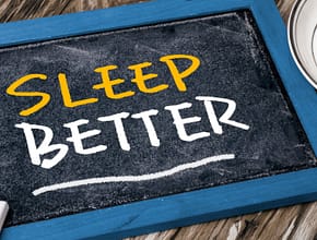 The words "Sleep Better" written on small chalk board