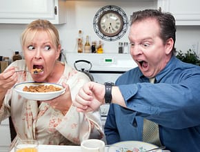 Stressed Couple in Kitchen Late for Work
